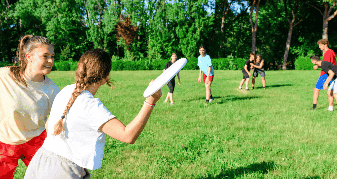 older campers playing with a frisbee