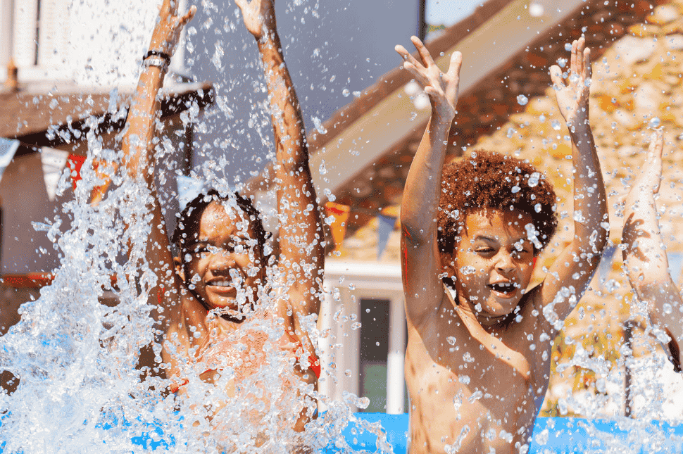 Stock two kids jumping into a pool